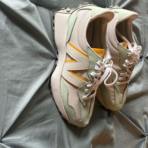 New balance 327 women’s  size 6 light blue, white, and yellow with gray bottom.